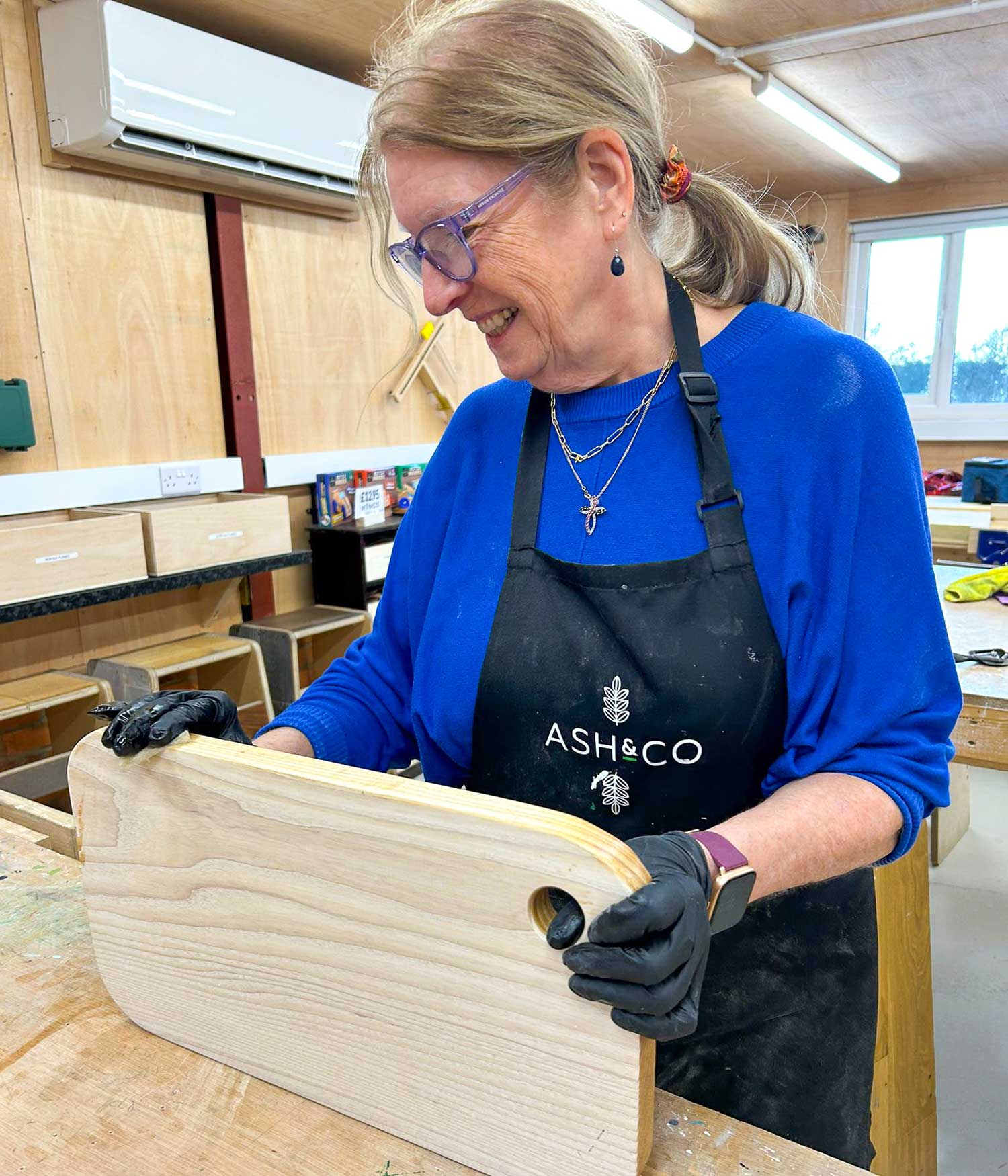 Applying finish to a hardwood chopping board made on a beginners one day woodwork class at Ash and Co Workshops in Hampshire.