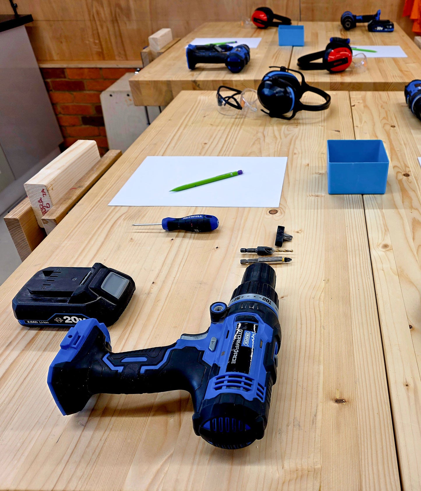 Beginner DIY course workbench set up with drills and tools ready for training