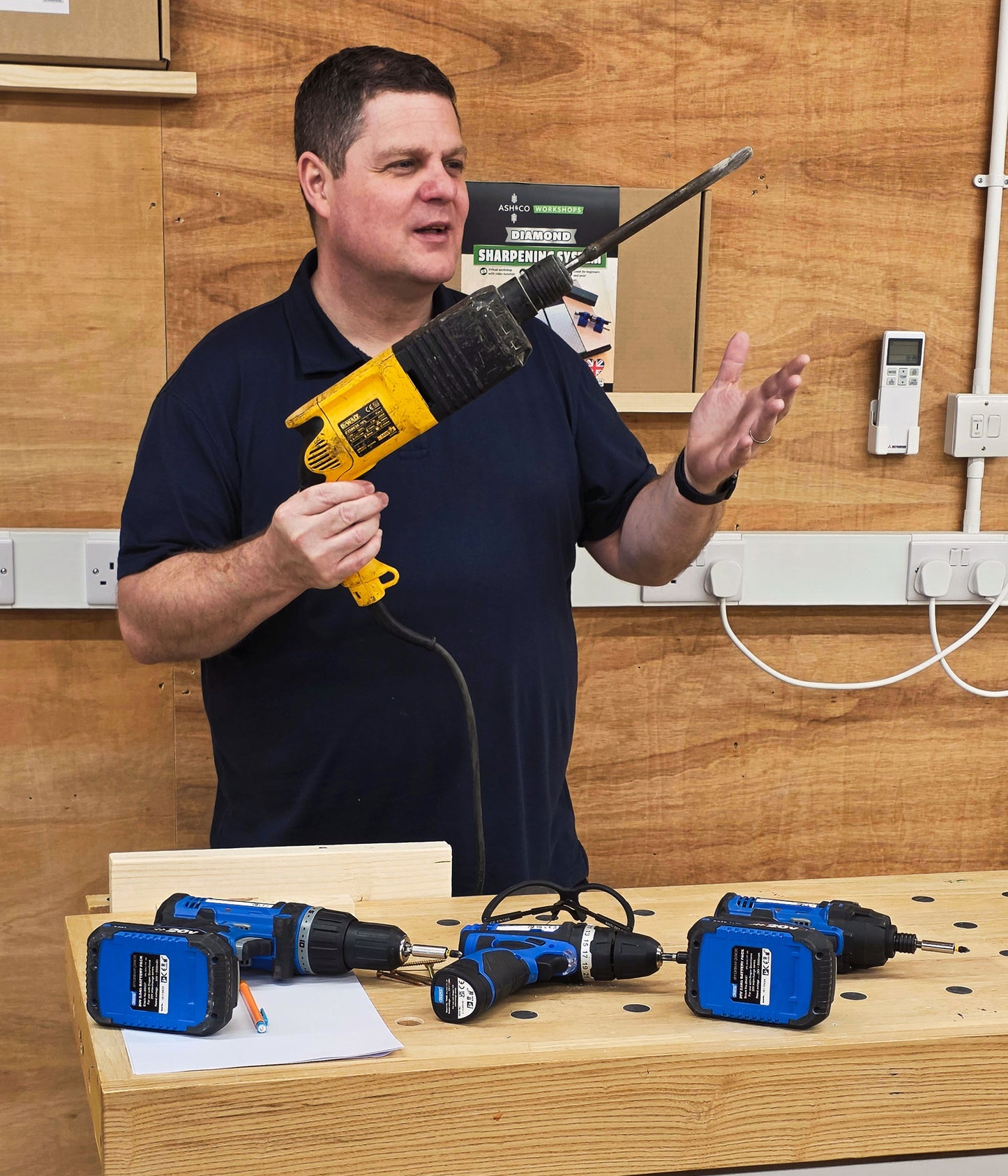 Instructor demonstrating electric drill during beginner DIY course
