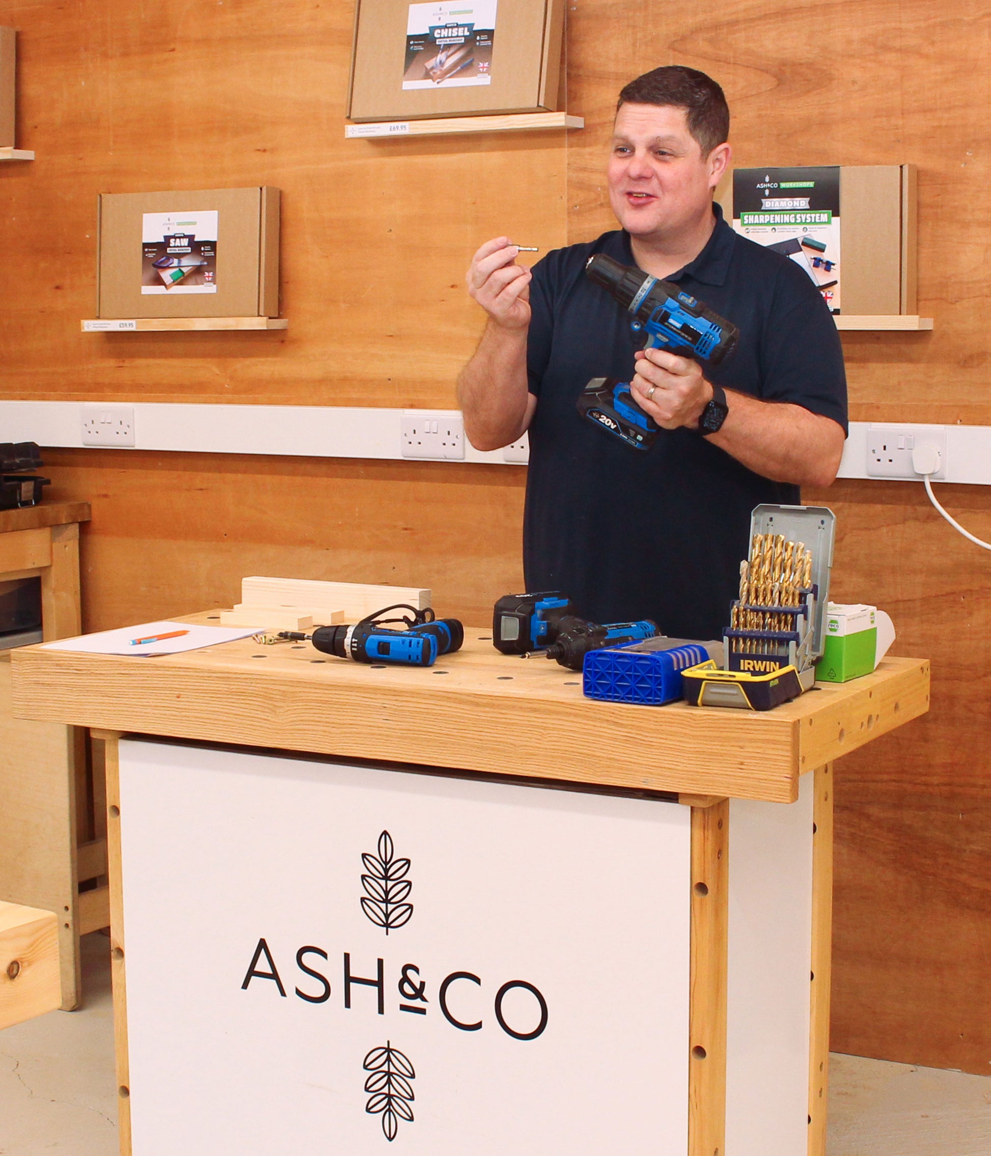 Instructor teaching how to use a drill on DIY course for beginners