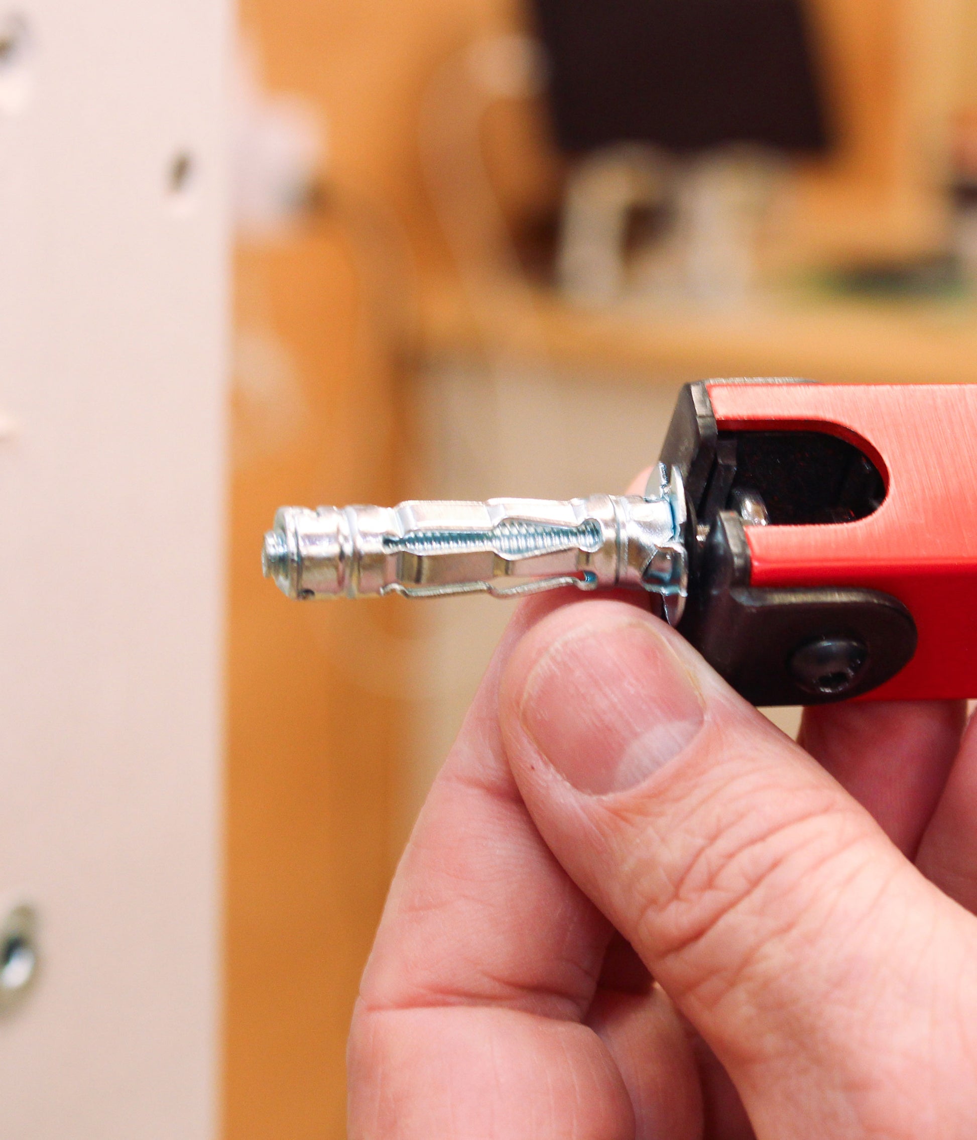 Wall plug being inserted to demonstrate fixing into plasterboard