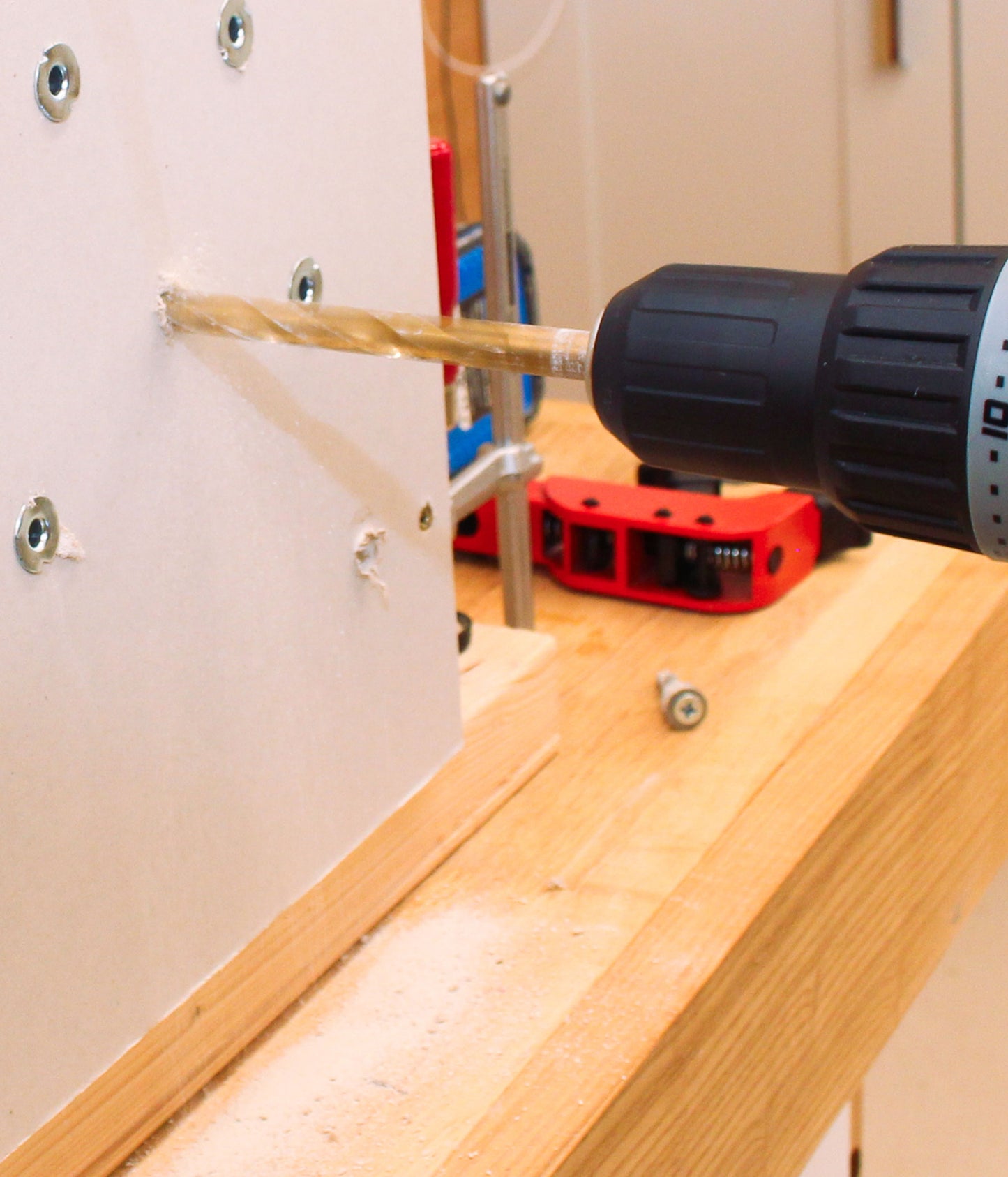 Drilling into wall during hands-on beginner DIY training course