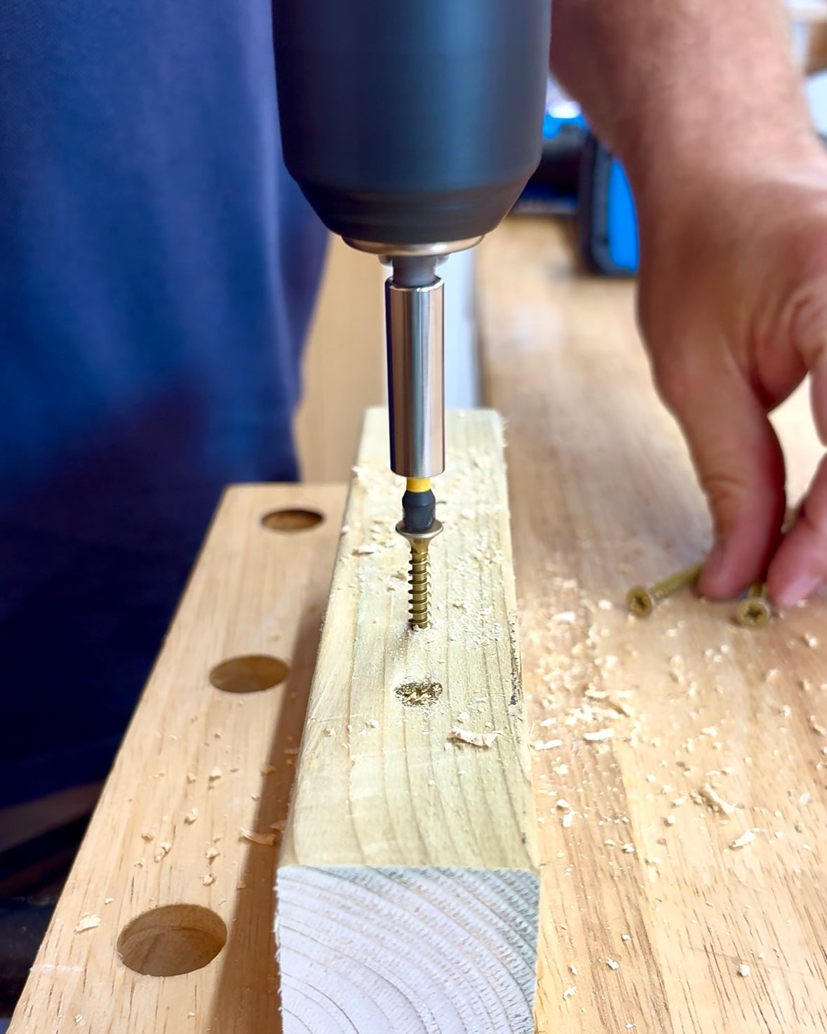 Hands-on practice drilling into a wooden block with a drill bit