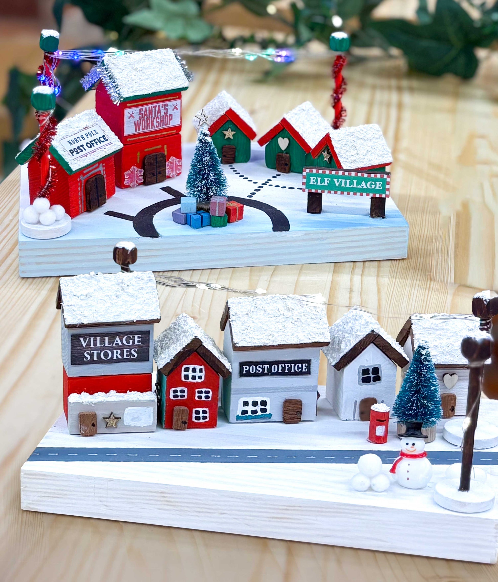 Christmas-themed villages with miniature houses and decorations on a wooden base - Craft kits for kids