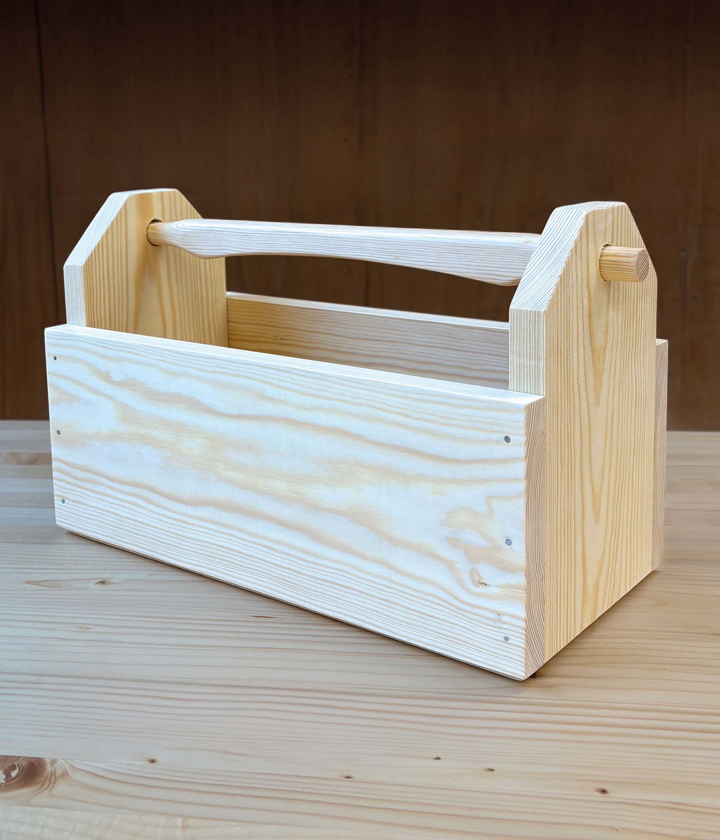 Wooden toolbox on a wooden surface with a brown background
