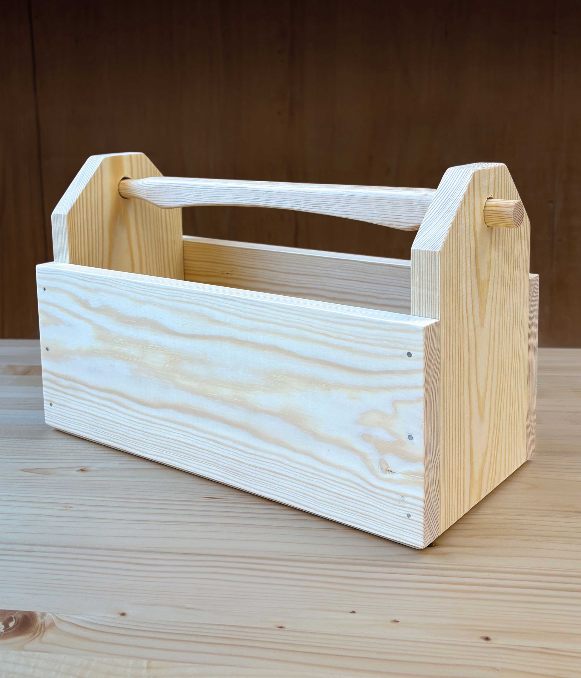 Wooden toolbox on a wooden surface with a brown background