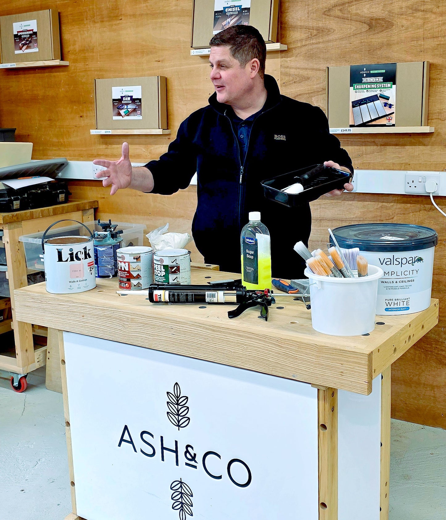 Instructor teaching decorating techniques during the Decorate in a Day workshop, demonstrating professional DIY painting skills for beginners.