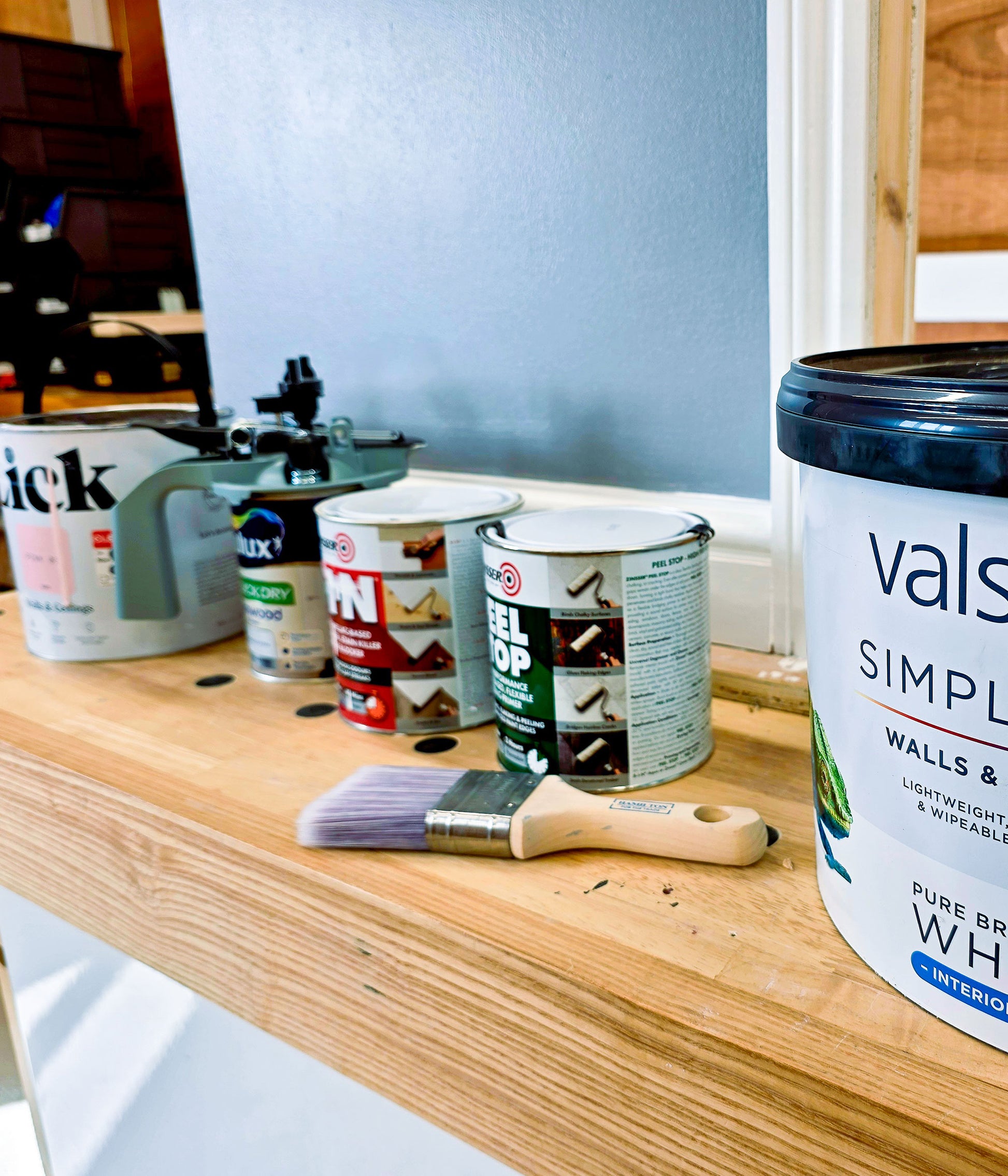 Paints and decorating products used during the Decorate in a Day workshop, including primers, interior paint and professional decorating tools.